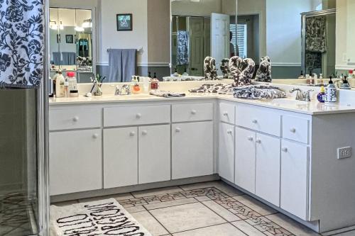 a bathroom with three sinks and a large mirror at Villa Euphoria in Cape Coral