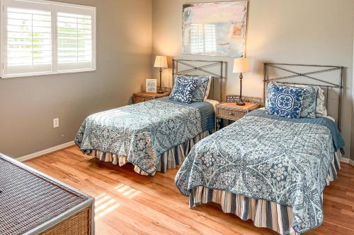 a bedroom with two beds and a window at Villa Euphoria in Cape Coral