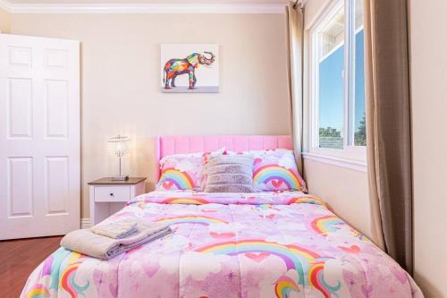 a bedroom with a pink bed with a unicorn blanket at Lavender house near Napa and San Francisco in Vallejo
