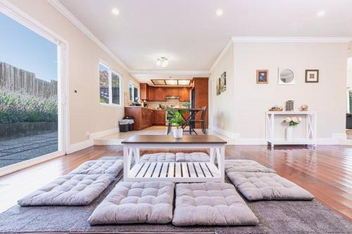 a living room with a table and a large window at Lavender house near Napa and San Francisco in Vallejo