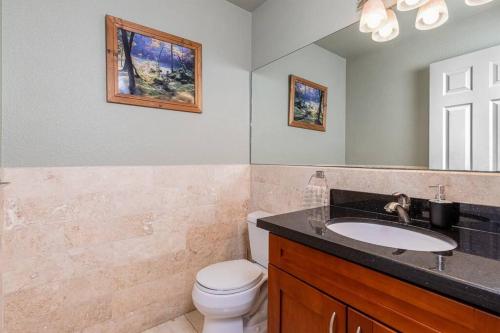 a bathroom with a white toilet and a sink at Lavender house near Napa and San Francisco in Vallejo