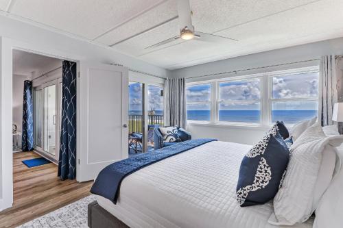 a bedroom with a bed with blue and white pillows at Amelia South C3 in Amelia Island
