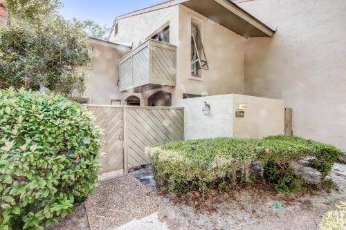 a house with a fence and bushes in front of it at 3050 Club Villas in Amelia Island