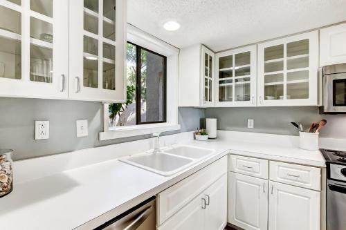 a kitchen with white cabinets and a sink at 3050 Club Villas in Amelia Island