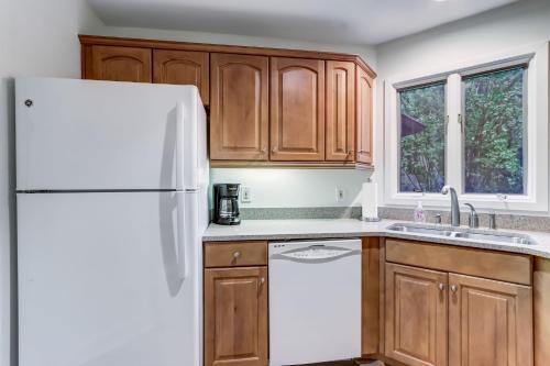 a kitchen with wooden cabinets and a white refrigerator at 2349 Courtside Villas in Amelia Island