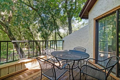 a patio with a table and chairs on a deck at 2349 Courtside Villas in Amelia Island
