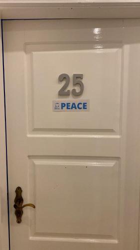 a white door with a peace sign on it at Blife Sun Hostel & Rooms in Faro
