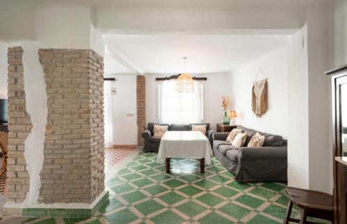 a living room with a couch and a table at Balcón a la Sierra - Terraza y Hermosas Vistas in Illora