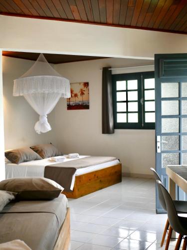 a bedroom with two beds in a room at Villa Clémence in Le François