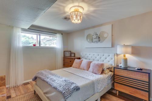 a bedroom with a white bed and a window at Chic Columbia City Vacation Rental with Kayaks! 
