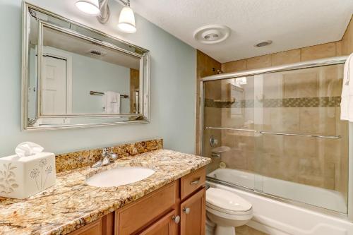 a bathroom with a sink and a shower and a toilet at 2123 Beach Wood in Amelia Island