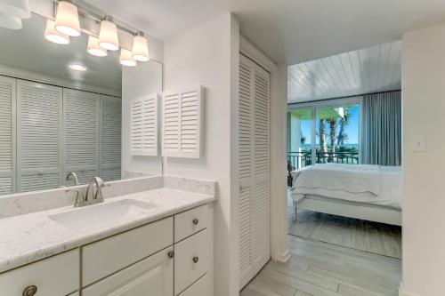 a bathroom with a sink and a bedroom with a bed at 1380 Shipwatch in Amelia Island