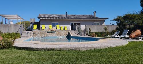 a swimming pool in front of a house at Villa Casa Brandao in Póvoa de Varzim
