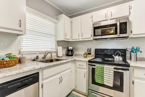 a kitchen with white cabinets and a sink at 2810 Ohio Avenue #1 in Amelia Island