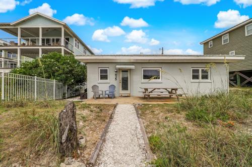 a white house with a picnic table in front of it at 435 Ocean Avenue in Amelia Island