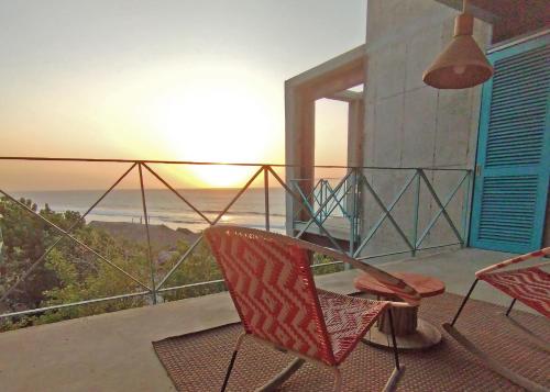 a balcony with two chairs and a view of the ocean at MuchoSur Manzanillo CTG in Cartagena de Indias
