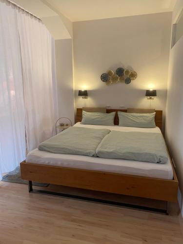 een slaapkamer met een groot bed met witte lakens bij Ferienwohnung am Park in Lahr
