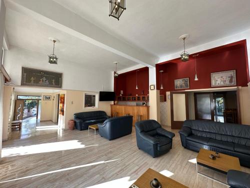 a living room with blue furniture and red walls at Hotel Galini in Parga