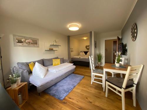 a living room with a couch and a table at Apartment am See in Zell am See