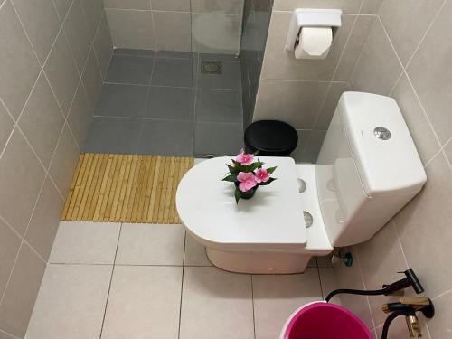 a bathroom with a toilet with pink flowers on it at Reylin Alanis Suite // Free Wifi & Netflix // Airport Shuttle Service in Sepang