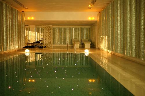 a pool in the middle of a room with at Salvator Villas & Spa Hotel in Parga