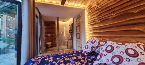 a bedroom with a bed and a large window at Stana de carti in Codlea