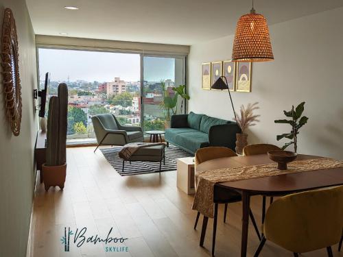 a living room with a couch and a table at Amazing City Views Condesa Roma By Bamboo Skylife in Mexico City
