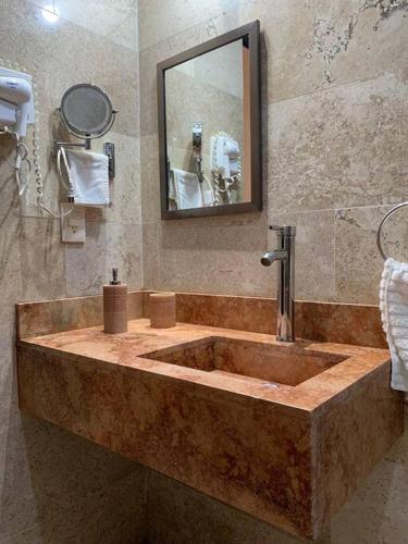 a bathroom with a large stone tub with a mirror at Casa entera Alberca en Acapulco Diamante in Acapulco