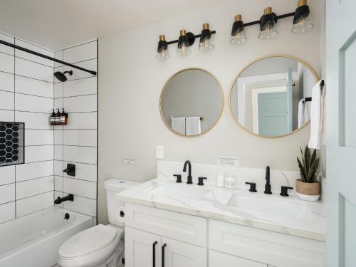 a white bathroom with a sink and a mirror at Peaceful 4br with Fire Pit and Huge Yard in San Diego