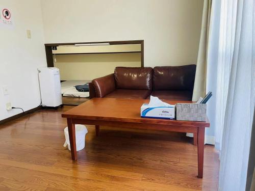 a living room with a couch and a coffee table at Real Corp 202 - Vacation STAY 78099v in Chiba
