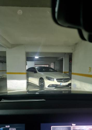 a white car is parked in a garage at The Episode - Jacuzzi Penthouses in Cluj-Napoca