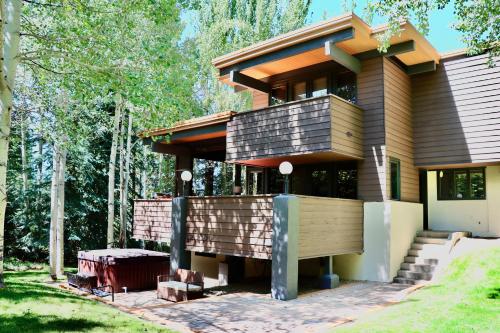a house in the woods with a porch at Aspen West End Sanctuary 4878 sf. in Aspen