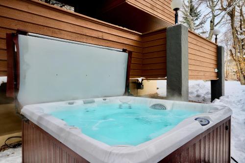 a jacuzzi tub in the snow next to a building at Aspen West End Sanctuary 4878 sf. in Aspen