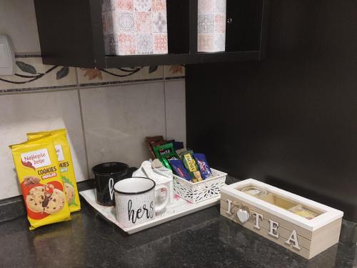 a kitchen counter with food and snacks on it at Apartman Jana in Bijeljina