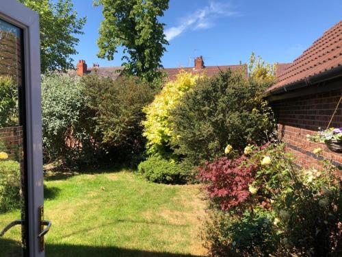 a garden view from the outside of a house at Double Bedroom in Crewe With Shared Kitchen and Bath in Crewe