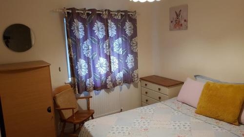 a bedroom with a bed and a dresser and a window at Double Bedroom in Crewe With Shared Kitchen and Bath in Crewe