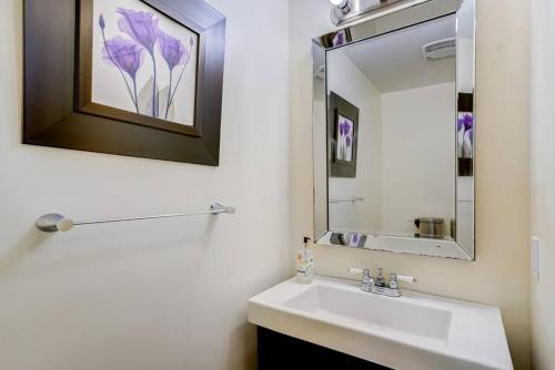 a white bathroom with a sink and a mirror at Luxury Home In Castlemore Brampton in Brampton