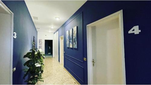 a hallway with blue walls and a blue door at Central Suite Bed&Breakfast in Bologna