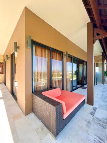 a living room with a couch on a balcony at Villa Mandalika Lombok in Kuta Lombok