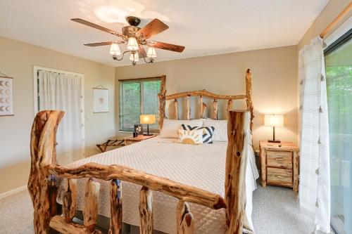 a bedroom with a wooden bed and a ceiling fan at Stunning Franklin Cabin with Deck and Mountain Views in Franklin