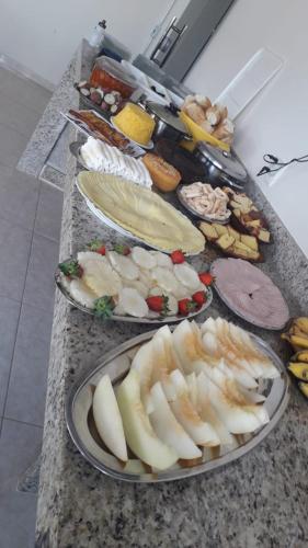 a counter with three plates of food on it at Hotel Raio do Sol in Ibicoara