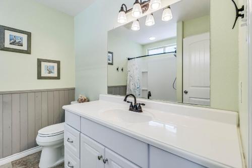 ein weißes Bad mit einem Waschbecken und einem WC in der Unterkunft Magnolia Street Magic in Rockport