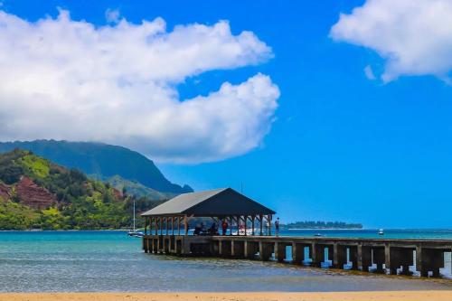 a pier with a gazebo on the water at Kiahuna Paradise at Poipu beach, newly remodeled in Koloa
