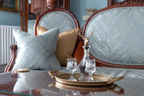 a tray with two wine glasses on a table at Plas Dinas Country House in Caernarfon