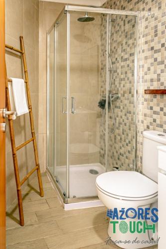 a bathroom with a shower and a toilet at Atlântida Dream T2 in Angra do Heroísmo
