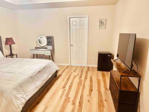 a bedroom with a bed and a television and a desk at House at Clear creek - Just 2 miles to Ft Cavazos , Adventhealth in Killeen