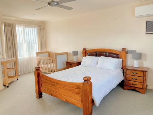a bedroom with a wooden bed and two night stands at The peaceful retreat in Mulgrave