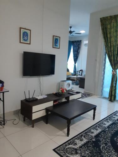 a living room with a flat screen tv on the wall at JHC Homestay Puncak in Kampung Bota Kiri