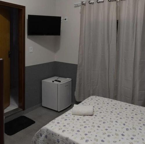 Postel nebo postele na pokoji v ubytování Pousada Gê