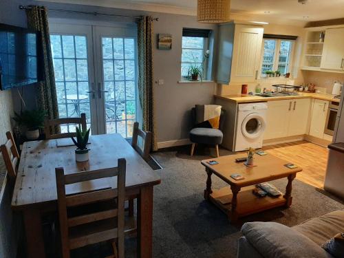 a kitchen and a living room with a table and a living room at Ground Floor Cornish Retreat Free Parking in Bodmin